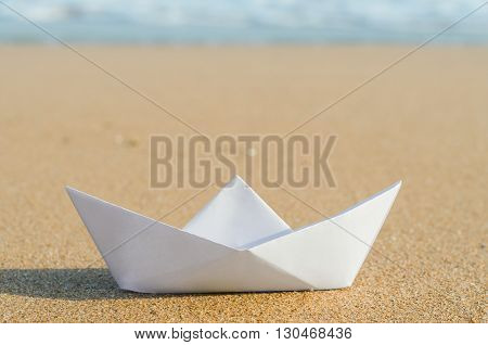 white paper boat on beach summer holiday
