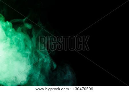 Abstract art. Virid smoke hookah on a black background. Inhalation. The steam generator. The concept of poison gas. Gas.