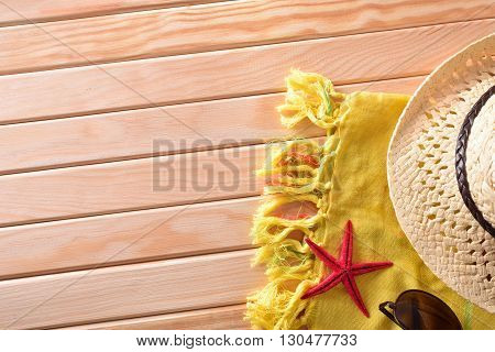 Articles of Beach on wooden slats.Sunglasses hat and towel. Horizontal composition. Top view