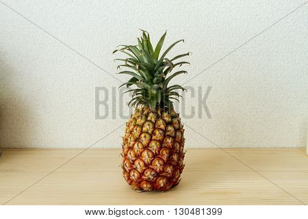 pineapple on a wood table . .