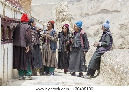 LAMAYURU INDIA - JUNE 15 2015: Unidentified buddhist old women during mystical mask dancing Tsam mystery dance in time of Yuru Kabgyat Buddhist festival at Lamayuru Gompa Ladakh North India