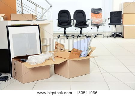 Move concept. Unpacking cardboard boxes in a new office