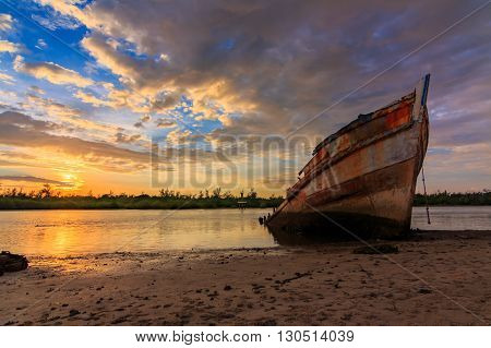 Abandoned Ship during sunset moment at Sabah Borneo Malaysia Image has grain or blurry or noise and soft focus when view at full resolution. (Shallow DOF, slight motion blur)