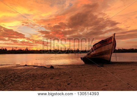 Abandoned Ship during sunset moment at Sabah Borneo Malaysia Image has grain or blurry or noise and soft focus when view at full resolution. (Shallow DOF, slight motion blur)