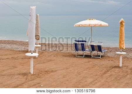 Beach Umbrella and Sun Bed in the Sandy Coast near the Italian City of Minori