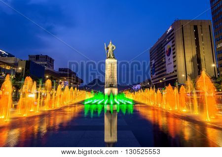 SEOUL SOUTH KOREA - APRIL 30 2016:Beautifully color water fountain at Gwanghwamun Plaza with the statue of the Admiral Yi Sun-sin in downtown.Photo taken on April 302016 in seoulSouth Korea.