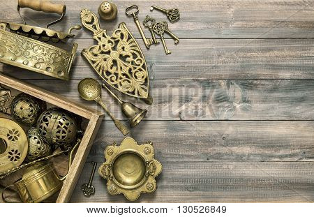 Vintage brass table ware. Kitchen table with antique tools and utensils