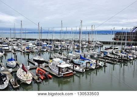 SAN FRANCISCO, USA - MAY 08, 2016: Yacht and sailboats docked at Pier 39 in San Francisco, California, USA.