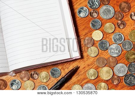 Blank piece of paper with pencil and coins