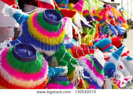 Mexican party pinatas decorated with fringed tissue colorful paper