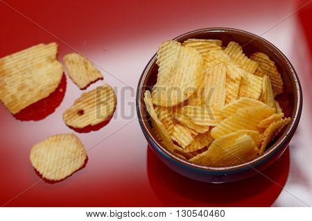 Rippled potato chips in a bowl closeup