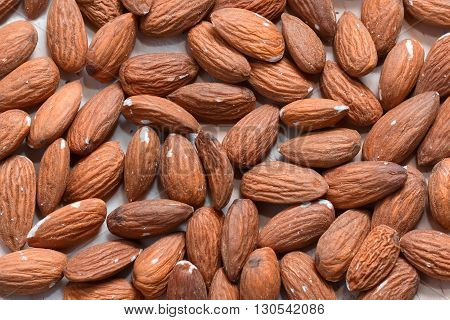 Many almonds without shell closeup background macro