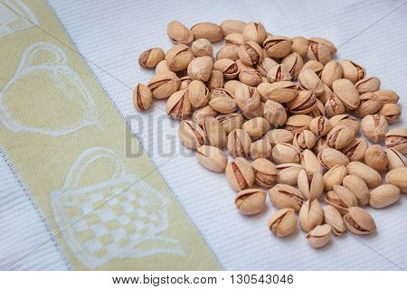 Pistachio nuts in a shell, salty, roasted on a table cloth