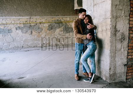 handsome guy and beautiful girl posing in a bystreet