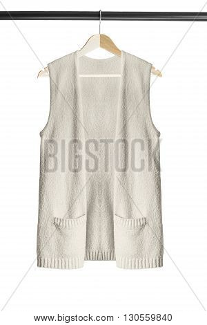 Beige cashmere vest on clothes rack isolated over white