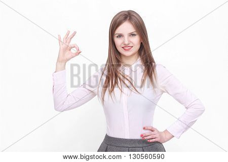 Young succesfull businesswoman gesturing ok or yes on isolated background