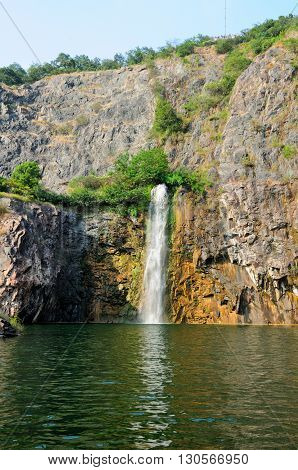 A waterfall flowing into the rock quarry at Chenshan Botanical Gardens in Songjiang District of Shanghai China.