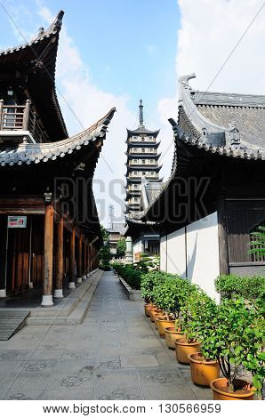 Inside of Zhenru Temple grounds in Shanghai China with the tower rising up in the background.