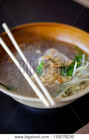 Fresh made thai glass noodle soup served with pork garlic and bean sprouts. Traditional thai cuisine.