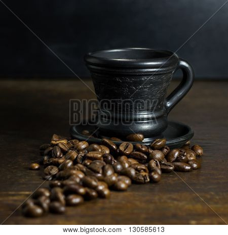 A cup of hot coffee on wooden background
