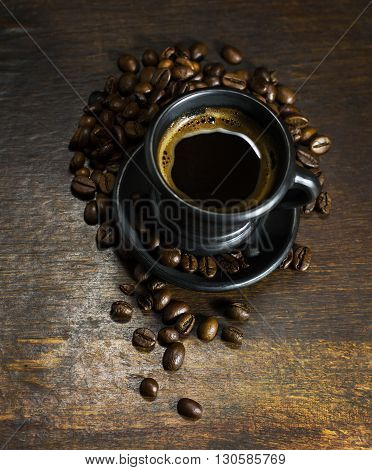 A cup of hot coffee on wooden background