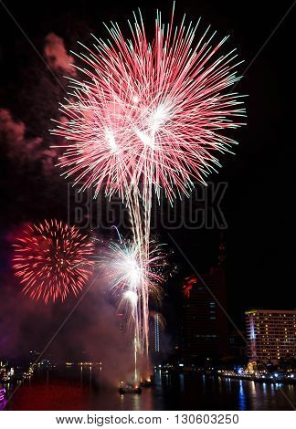 Fireworks over Chaopraya river near hotel in Bangkok Thailand