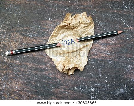 concept creased paper of idea and broken pencils on wooden table