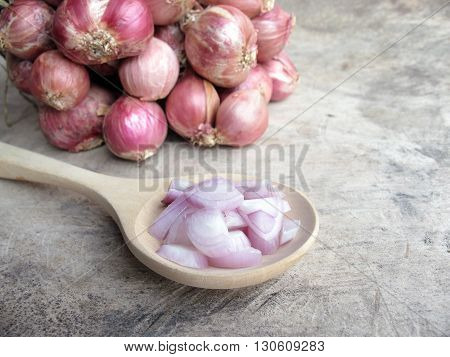 raw red onion slice small size on wooden spoon