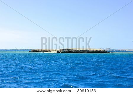 Island in the Sea. Sea Blue Water Background.