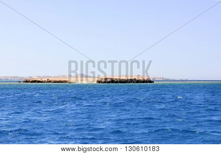 Island in the Sea. Sea Blue Water Background.