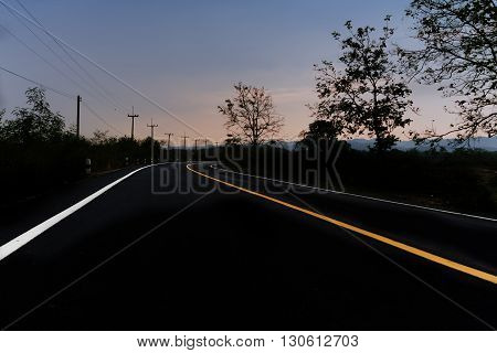 Country Road to the end with twighlight blue sky