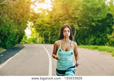 Young woman running in the Park . Sports girls