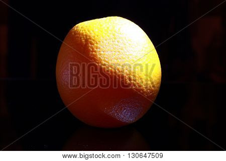 Orange fruit isolated on black background, dark