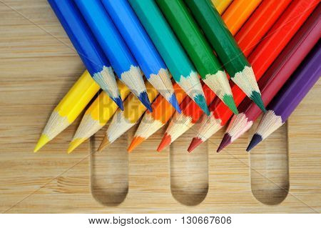 Colored pencil composition on wooden table background