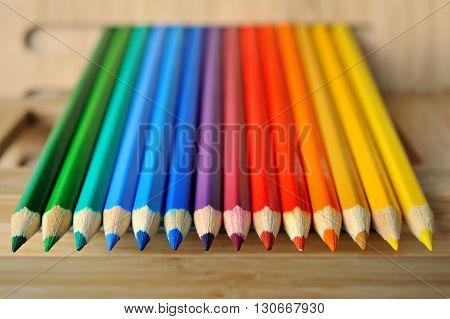 Color pencil palette on textured wooden background