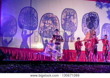 RATCHABURI THAILAND - APRIL 14 2015: The Cowskin shows a man holding a stencil pattern. Moving Cowskin the light to shadow play. The musical atmosphere and read a poem composed. In a traditional culture. There are performances every year Thailand in SONGK