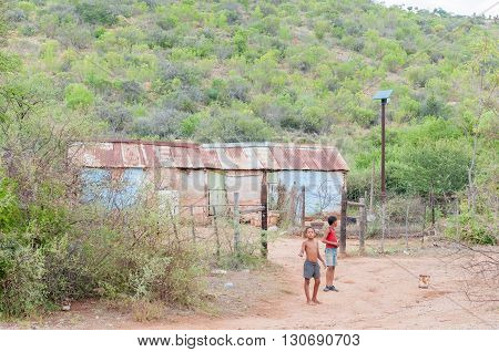 BAVIAANSKLOOF SOUTH AFRICA - MARCH 6 2016: Unidentified children in front of their house in the Baviaanskloof (baboon valley). The house is fitted with solar power