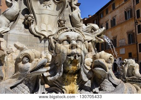 Grotesque marble head among strange fish from the Fountain of the Pantheon designed by Giacomo della Porta in 1575