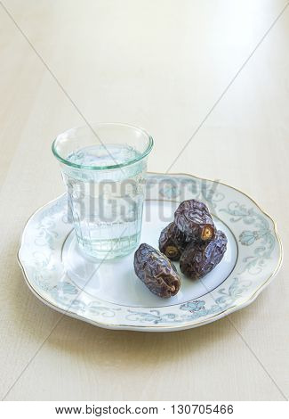 A glass of water and ripped dates - a food that is consumed while breaking fast during holy month of Ramadan