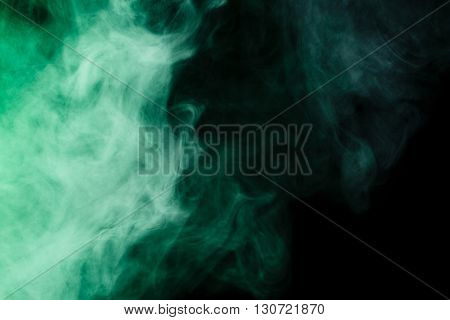 Abstract art. Virid smoke hookah on a black background. Inhalation. The steam generator. The concept of poison gas. Gas.