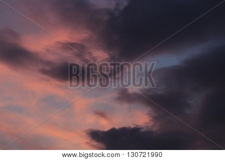 Sunset with cloudy orange sky. Meteorology. Synoptics. Changes in the weather. Cloud Front.