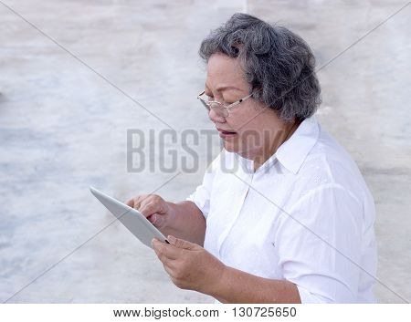 Old Asian Grandmother Watch And Touch Tablet