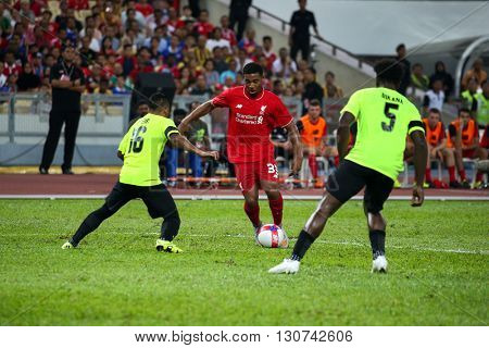 July 24, 2015- Shah Alam, Malaysia: Liverpool's Jordan Ibe (red) dribbles the ball in a friendly match against the Malaysian Team. Liverpool Football Club from England is on an Asia tour.