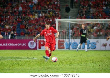 July 24, 2015- Shah Alam, Malaysia: Liverpool's James Milner passes the ball in a friendly match against the Malaysian Team. Liverpool Football Club from England is on an Asia tour.