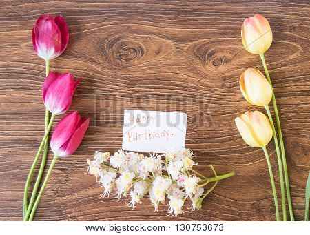 Beautiful Flowers Tulips And Chestnuts On A Wooden Table