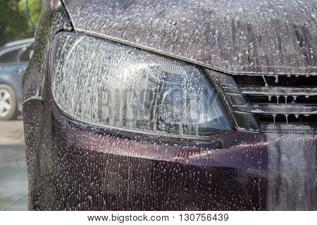 Car headlights with power buffer machine at service station - a series of CAR CARE images.