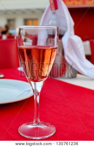 A glass of rose wine with a lip stain