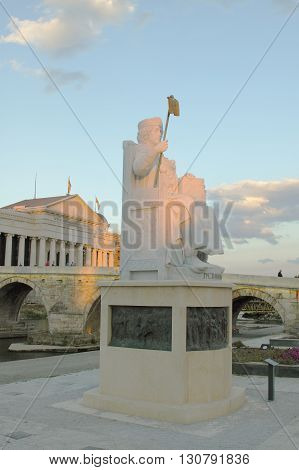 Macedonia Skopje Emperor Iusinianus Statue Stone Bridge and Archeological Museum in the background sunset