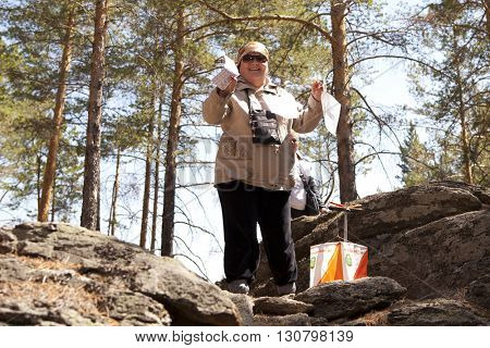 RUSSIA, ULAN-UDE - MAY 22, 2016: Russian Azimut - 2016. Orienteering competition is held annually in the Buryatia region. People at at control point at orienteering course.