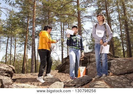 RUSSIA, ULAN-UDE - MAY 22, 2016: Russian Azimut - 2016. Orienteering competition is held annually in the Buryatia region. People at at control point at orienteering course.